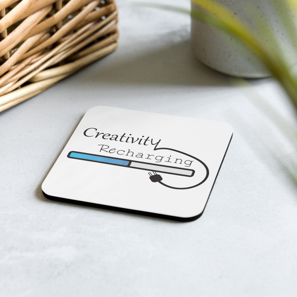 Coaster with 'Creativity Recharging' design on a light surface