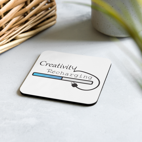 Coaster with 'Creativity Recharging' design on a light surface