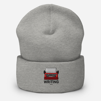 Gray beanie with a red typewriter and 'WRITING' text embroidery on a white background