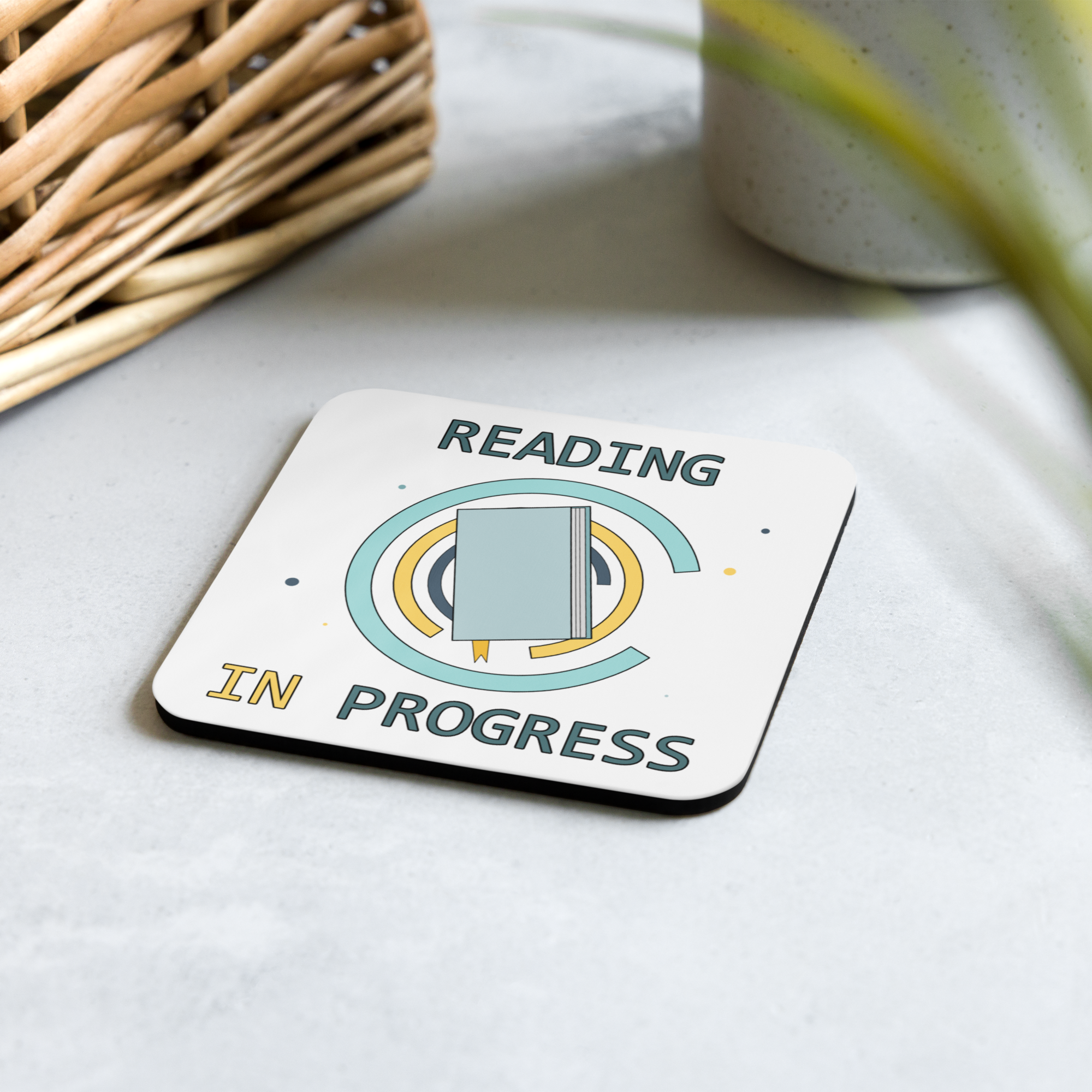 Coaster with 'Reading in Progress' design on a light surface